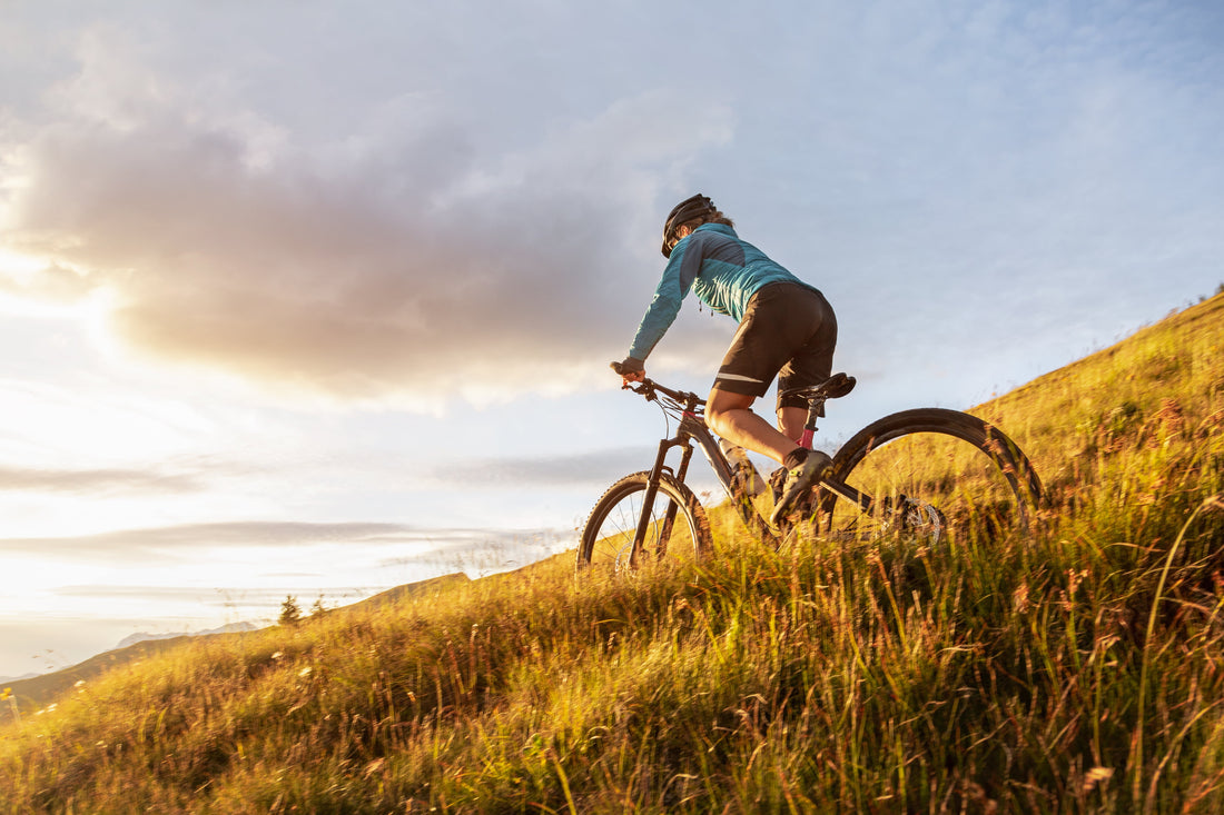 female MTB rider on hill