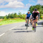 road cyclists riding on country roads on a sunny day